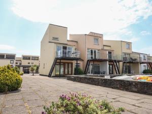 an apartment building with balconies and a courtyard at Moelwyn 57D South Snowdon Wharf in Porthmadog