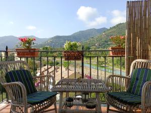 a balcony with two chairs and a table with a view at Casa Oliveta in Rapallo