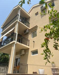 a building with balconies on the side of it at Apartmani Bekonja in Tivat
