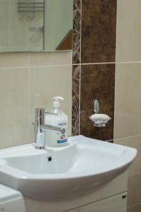 un lavabo con una botella de jabón. en Villa Pari Apartment en Kotor