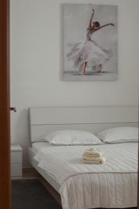 a bedroom with a bed with a picture of a ballet dancer at Villa Pari Apartment in Kotor