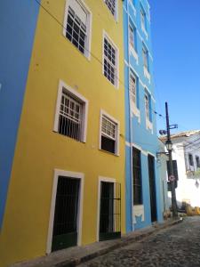 a yellow and blue building on a street at No coração do Pelourinho, perto de tudo. in Salvador