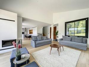 a living room with two couches and a table and a living room at Villa moderne Jaizkibel in Hondarribia