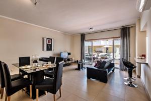 a dining room and living room with a table and chairs at Formosa Cabanas Beach in Cabanas de Tavira