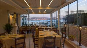 a restaurant with tables and chairs on a balcony at Il Cantuccio b&b in Bacoli