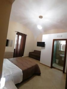 a bedroom with a bed and a couch in it at Il Cantuccio b&b in Bacoli +13 photos