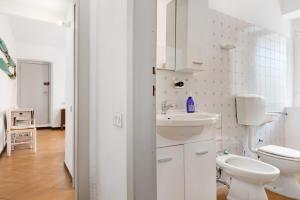 a white bathroom with a sink and a toilet at Oceane Paradise- Charlot in Levanto +16 photos
