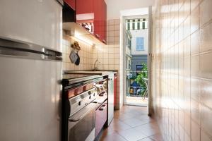 a kitchen with a stove top oven in a room at Oceane Paradise- Charlot in Levanto