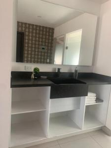 a bathroom with a sink and a mirror at San Miguel Cabañas in Valle de Guadalupe