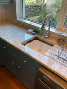 a kitchen counter with a sink and a window at Wyresdale 7 Limethwaite in Windermere