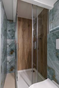 a shower with a glass door in a bathroom at My CASA - SAINT SIAGRE 3 in Nice