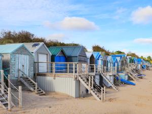 a row of colourful beach huts on the beach at Harbour View in Abersoch