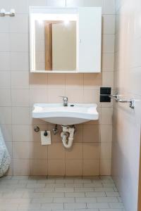 a bathroom with a white sink and a mirror at SE008 - Senigallia, bilocale sul mare con spiaggia in Senigallia