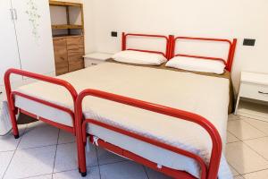 a bedroom with two beds with white and red frames at SE008 - Senigallia, bilocale sul mare con spiaggia in Senigallia