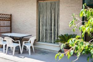 a table and chairs on a patio with a window at SE008 - Senigallia, bilocale sul mare con spiaggia in Senigallia