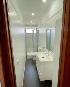 a bathroom with a sink and a toilet and a mirror at Las Canteras View Home in Las Palmas de Gran Canaria