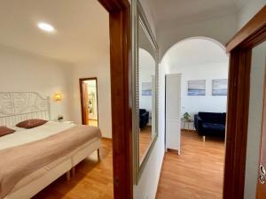 a bedroom with a bed and a living room at Las Canteras View Home in Las Palmas de Gran Canaria