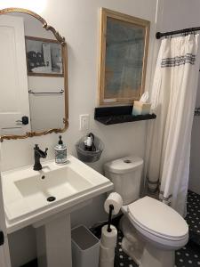 a bathroom with a white sink and a toilet at Painted Lady Bed & Brew in Albuquerque