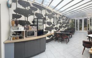 a restaurant with a wall with cows painted on it at Hipotel Lilas Gambetta in Paris