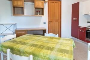 a kitchen with a table with a yellow table cloth on it at SE010 - Senigallia, bilocale sul mare con spiaggia in Senigallia