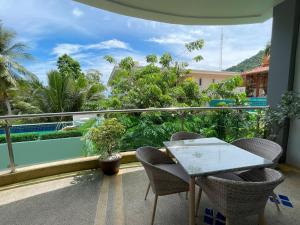 a balcony with a table and chairs and a view at Kata Top View by Lofty in Kata Beach