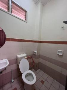 a bathroom with a toilet and a sink at Perdana Cottage, Peaceful & Cozy Residential Area in Sungai Petani