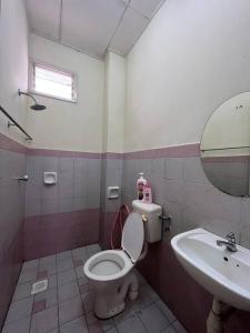 a bathroom with a toilet and a sink at Perdana Cottage, Peaceful & Cozy Residential Area in Sungai Petani