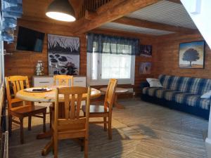 a living room with a table and chairs and a couch at Kallioranta in Lestijärvi