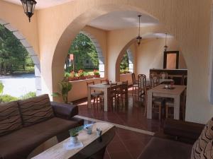 a living room with a couch and tables and chairs at Vacation Home Keskic in Velika Gata