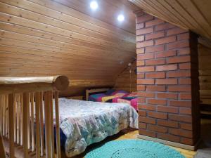 a bedroom with two beds and a brick wall at Kallioranta in Lestijärvi