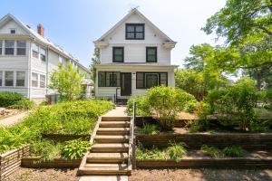 a house with a staircase leading to a garden at Linden Hills Luxury Charmer in Minneapolis