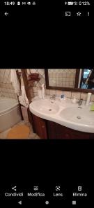 a picture of a bathroom with a sink and a tub at Chalet quota 1800 in Saint Jacques