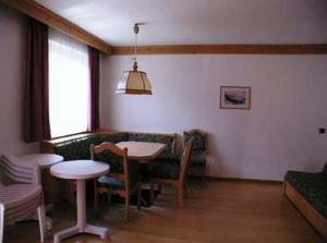 a living room with a table and a couch at Residence Unterhuber in San Candido