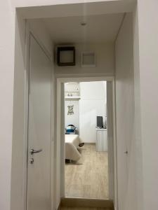 ein Flur, der zu einem Schlafzimmer mit einem Bett führt in der Unterkunft CASA VACANZE IL FONDACO in Giovinazzo