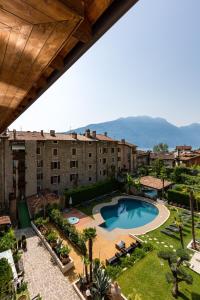 a view of a resort with a pool and buildings at Casa Canarino in Riva del Garda