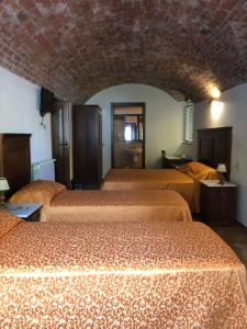 a hotel room with three beds in a room at Albergo Miramonti in Comano