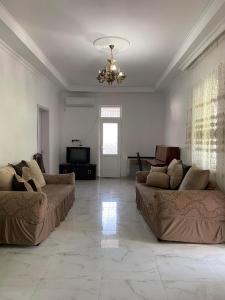 a living room with two couches and a chandelier at Resort In Gonio in Kvariati