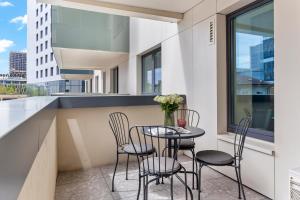 a balcony with a table and chairs and a window at Aviation Tower Luxury Apartments in Bucharest
