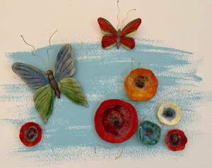 a painting of butterflies and fruit on a table at BONATSA ROOMS in Palaiochora +28 photos