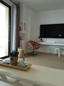 a living room with a large flat screen tv at Vista mare by Oikies Rentals in Neoi Epivates