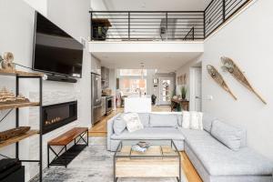 a living room with a couch and a fireplace at Contemporary Zen Townhome with a View - Wash Park in Denver