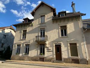 a white building with a cross on top of it at La petite chouette in Rochesson