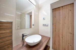 a bathroom with a white sink and a mirror at Penzion SALAŠ in Salaš