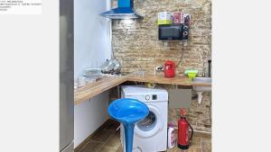 a kitchen with a washing machine and a sink at CAMP NOU & FiRA BUSINESS LOFTS in Barcelona