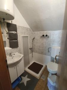 a bathroom with a sink and a toilet and a shower at Holiday Home Jere in Postira