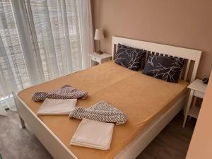 a bedroom with a bed with two towels on it at Jurič in Rogoznica