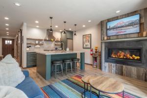 a kitchen and a living room with a fireplace at Northstar Bike Hike Ski In and Out Condo Pools Hot Tubs Courts Walk to Village in Truckee