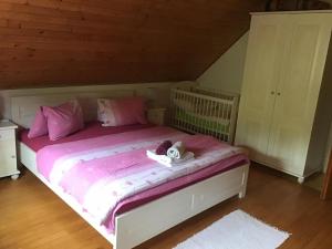 a bed with a stuffed animal on top of it at Chata pod Rozsutcom in Biela
