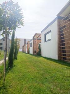 a yard with a row of houses and trees at Tiny Village Mamaia Nord - House 2 in Mamaia Nord