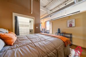 a bedroom with a large bed and a window at Elevated Route 66 ABQ Penthouse- An Irvie Home in Albuquerque